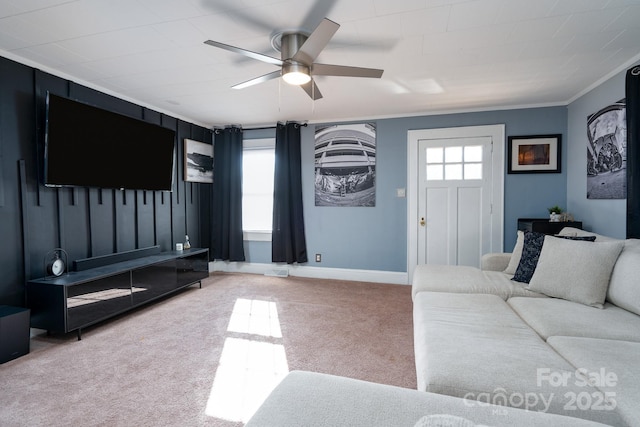 living room with a wealth of natural light, ornamental molding, ceiling fan, and carpet flooring