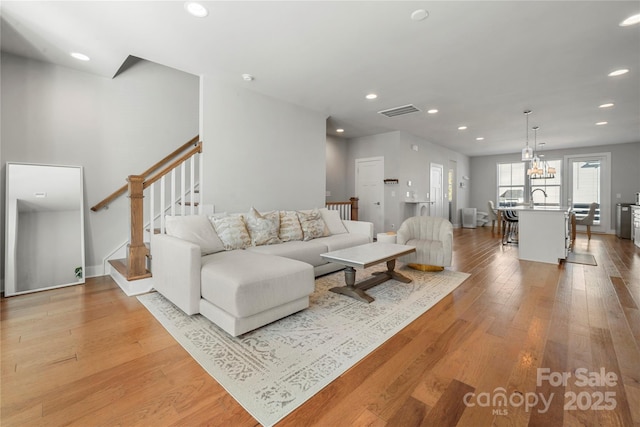 living room with sink and light wood-type flooring