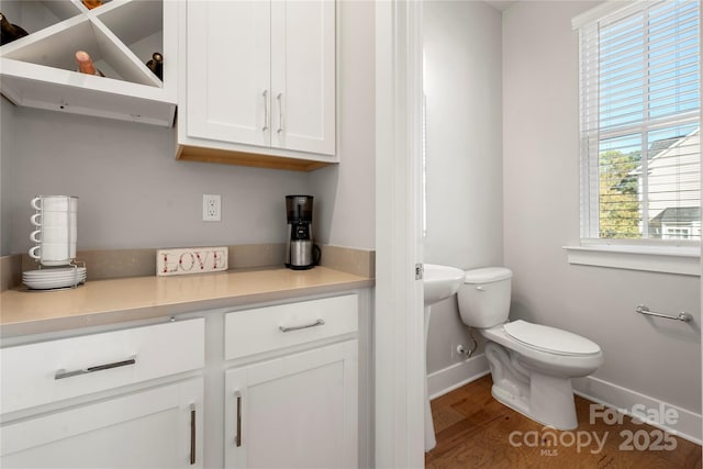 bathroom featuring hardwood / wood-style floors and toilet