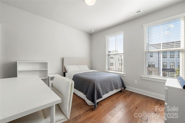 bedroom with dark wood-type flooring