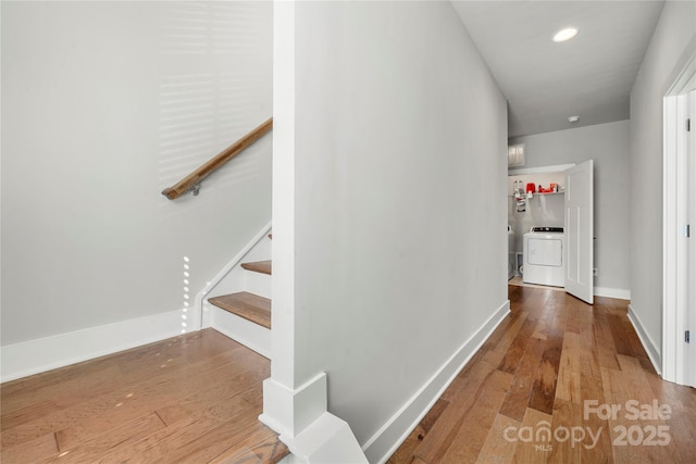 hallway featuring hardwood / wood-style flooring and washer / dryer