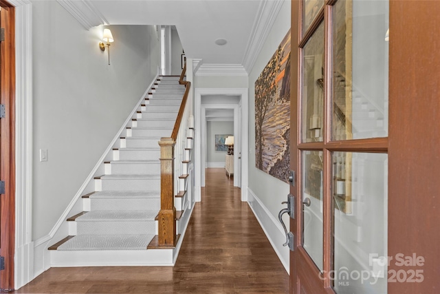 foyer entrance featuring dark hardwood / wood-style flooring and crown molding