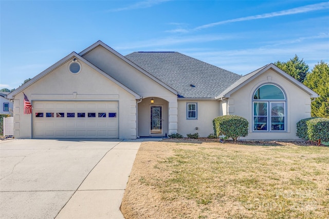 ranch-style house with a garage and a front lawn