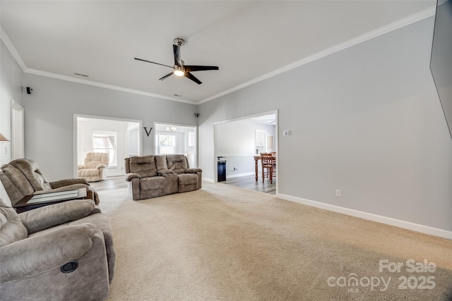 carpeted living room with ceiling fan and ornamental molding