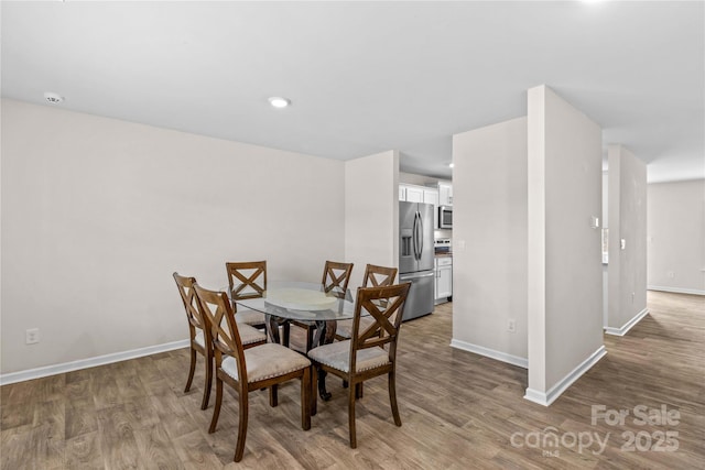 dining room with hardwood / wood-style floors