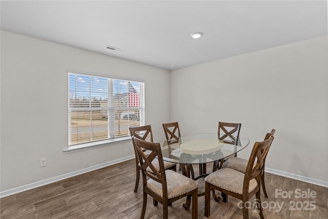 dining space featuring dark hardwood / wood-style flooring