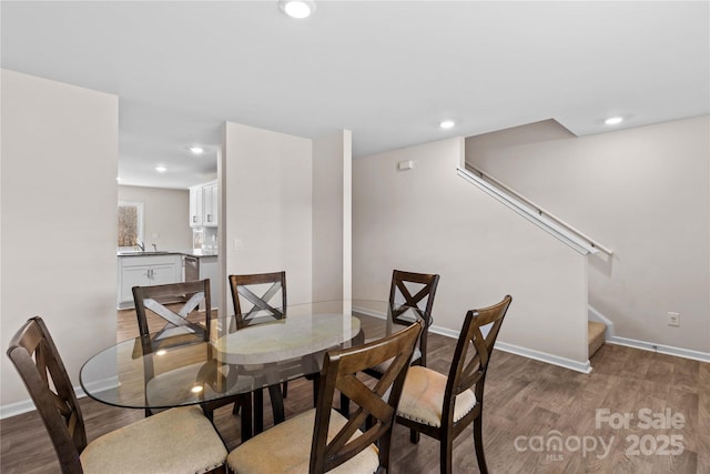 dining space featuring sink and hardwood / wood-style floors