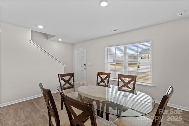 dining space with light hardwood / wood-style floors