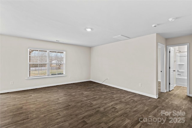 spare room with dark hardwood / wood-style flooring