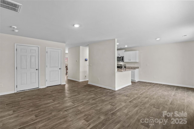 unfurnished living room featuring dark wood-type flooring