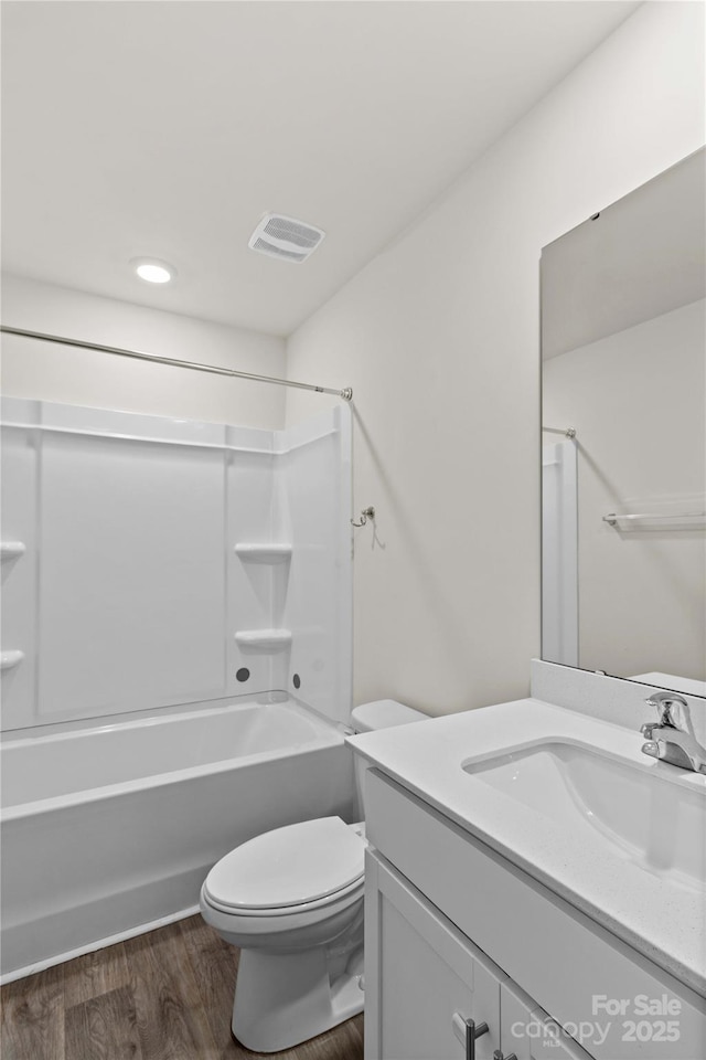 full bathroom featuring toilet, wood-type flooring, bathtub / shower combination, and vanity