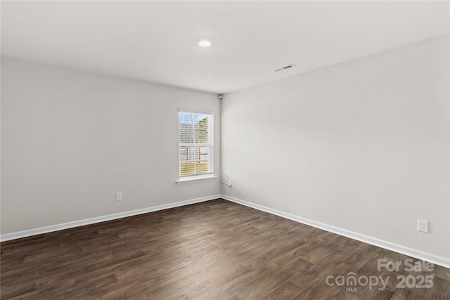 unfurnished room featuring dark hardwood / wood-style floors