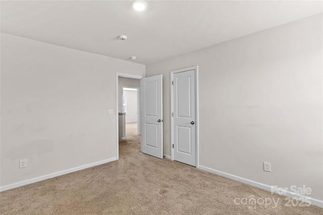 unfurnished bedroom with light colored carpet