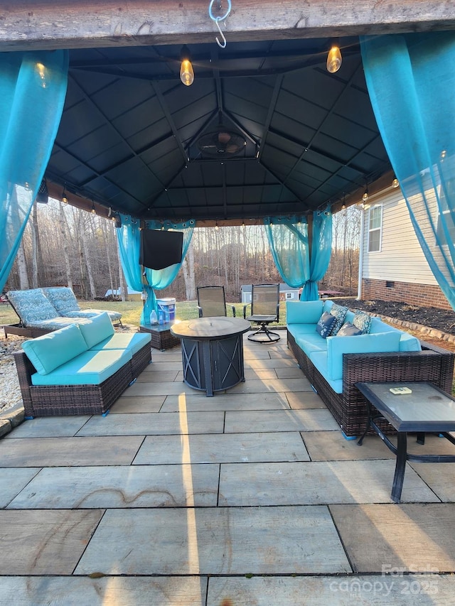 view of patio with an outdoor living space and a gazebo