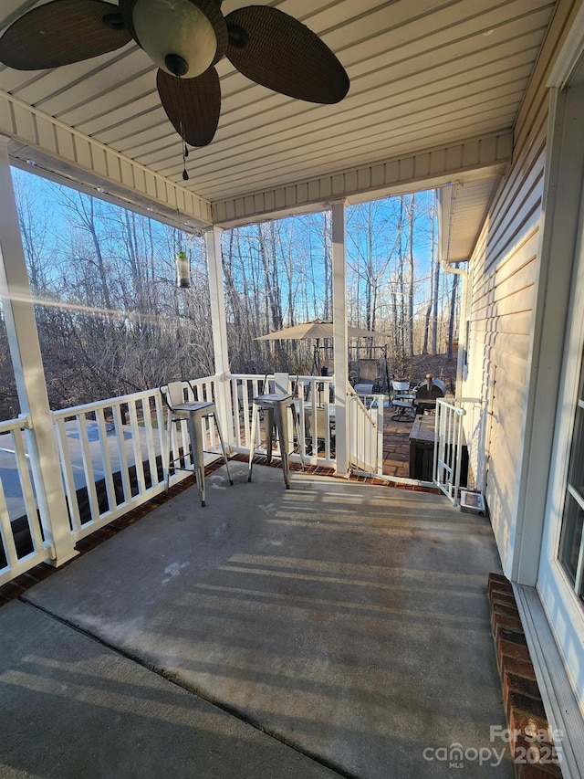 wooden deck featuring ceiling fan