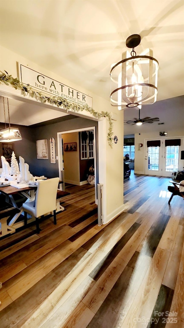 dining room with wood-type flooring and a chandelier