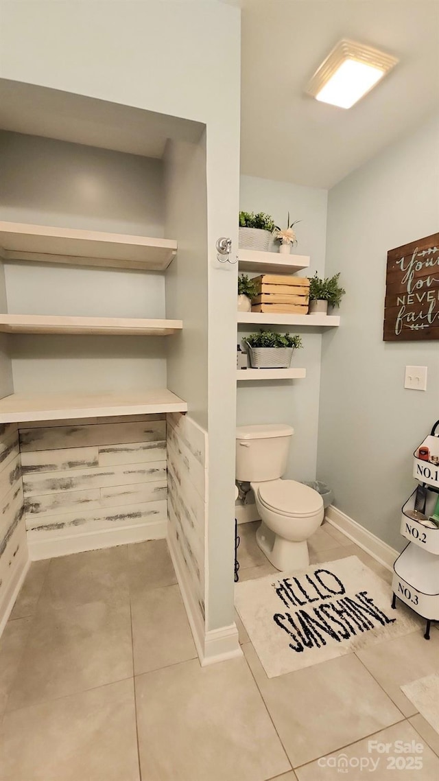 bathroom with tile patterned floors and toilet