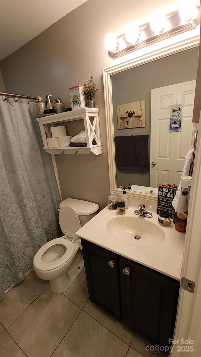 bathroom featuring vanity, vaulted ceiling, tile patterned floors, and toilet