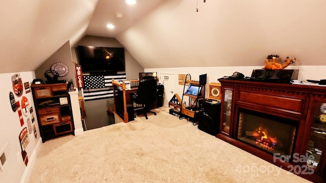 carpeted office featuring lofted ceiling