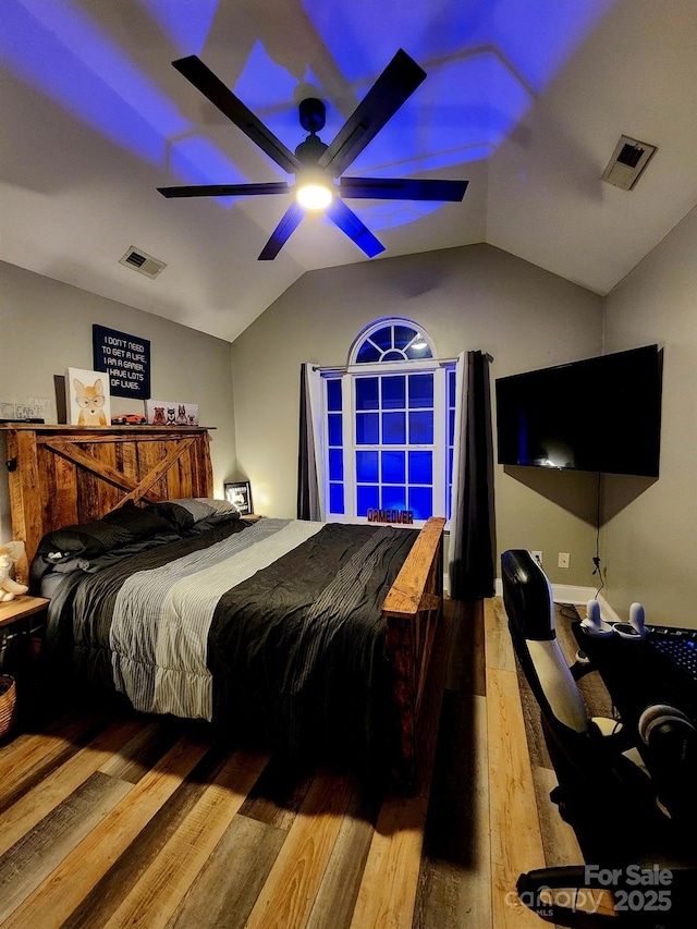 bedroom featuring ceiling fan, wood-type flooring, and vaulted ceiling