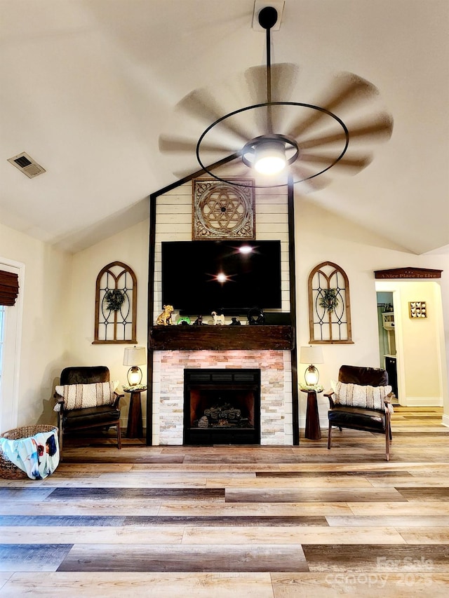306 Bluegill Ln, Statesville, NC 28625 - living area with lofted ceiling, a fireplace, visible vents, ceiling fan, and wood finished floors