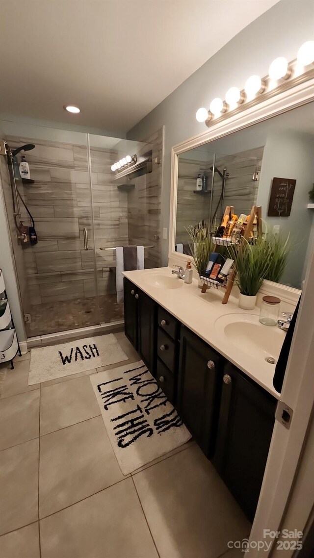 306 Bluegill Ln, Statesville, NC 28625 - full bath featuring a shower stall, tile patterned flooring, double vanity, and a sink