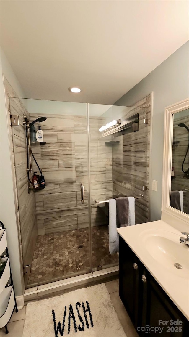 306 Bluegill Ln, Statesville, NC 28625 - bathroom featuring tile patterned flooring, a shower stall, and vanity