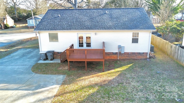 back of property with a yard, french doors, central air condition unit, and a deck