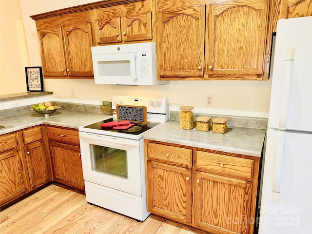 kitchen featuring white appliances and light wood-type flooring