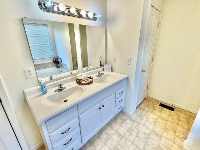 bathroom with vanity and a tub to relax in