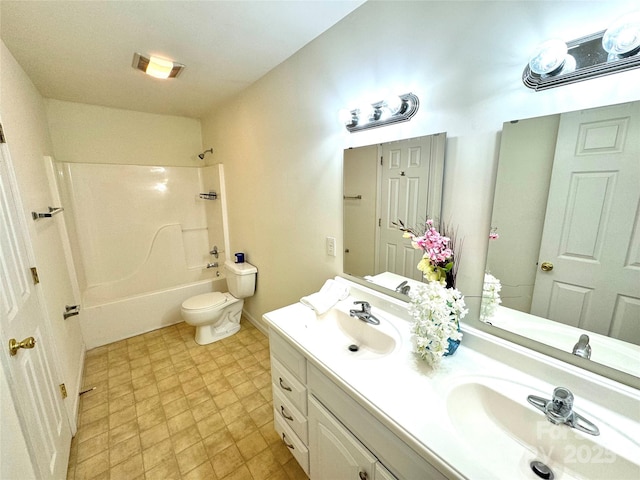 full bathroom featuring vanity, shower / washtub combination, and toilet