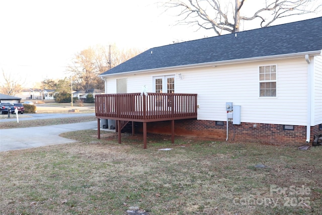 back of house featuring a deck and a lawn