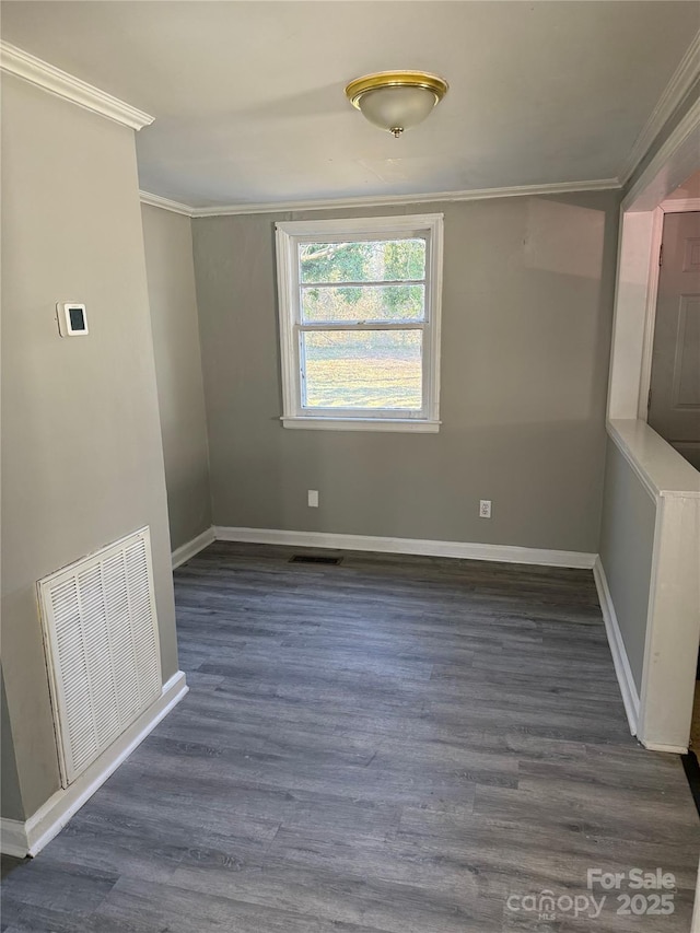 spare room with dark hardwood / wood-style flooring and ornamental molding