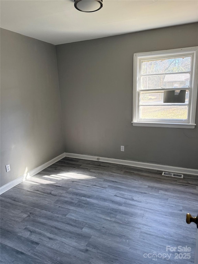 spare room featuring dark wood-type flooring