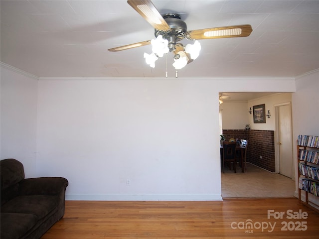 living room with hardwood / wood-style flooring, ceiling fan, and ornamental molding