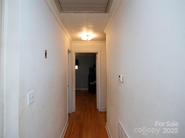 hall with ornamental molding and hardwood / wood-style floors