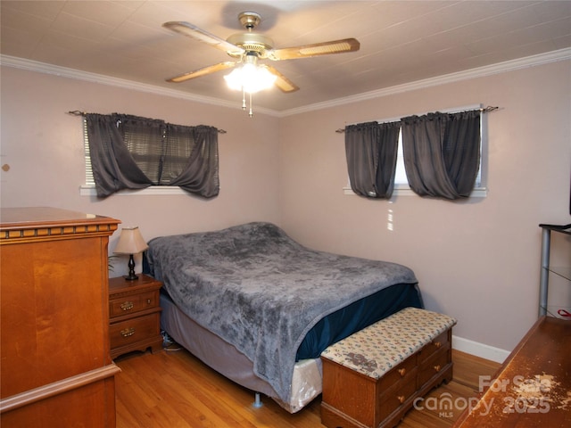 bedroom featuring crown molding, ceiling fan, and light hardwood / wood-style floors