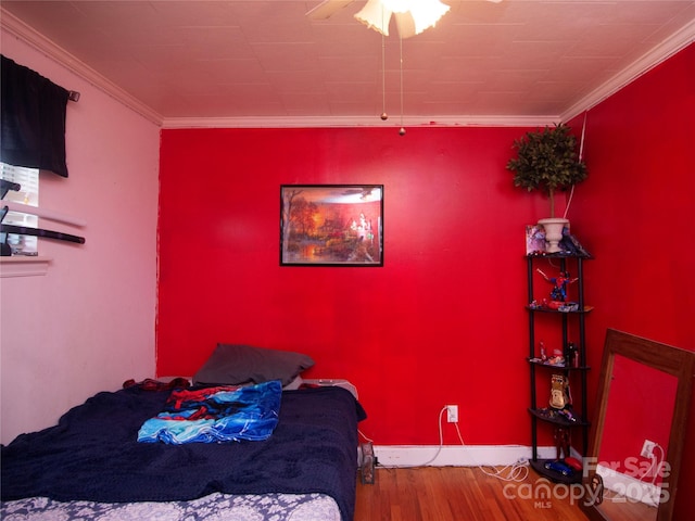 bedroom with hardwood / wood-style flooring and crown molding