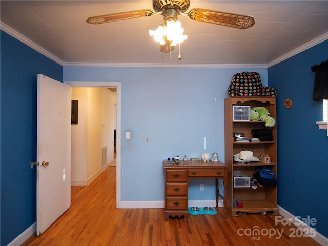 office area with crown molding, wood-type flooring, and ceiling fan