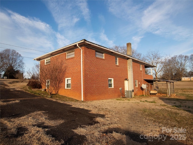 view of side of property featuring central AC unit