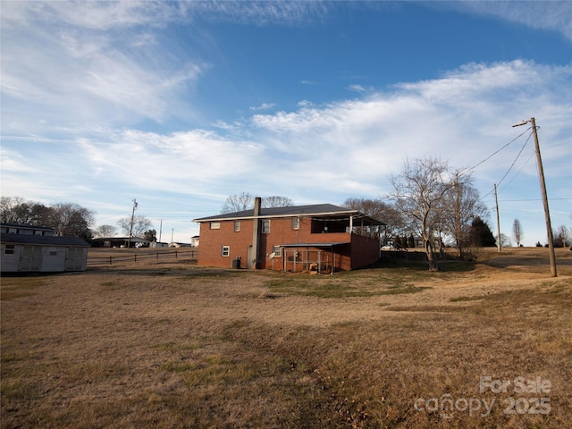 rear view of property with a yard