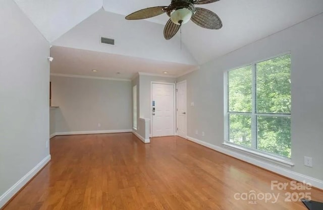 unfurnished room with ceiling fan, vaulted ceiling, and wood-type flooring