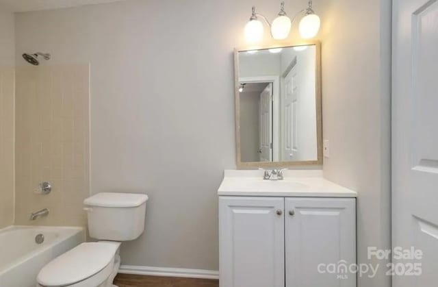 full bathroom with vanity, toilet, and tiled shower / bath combo