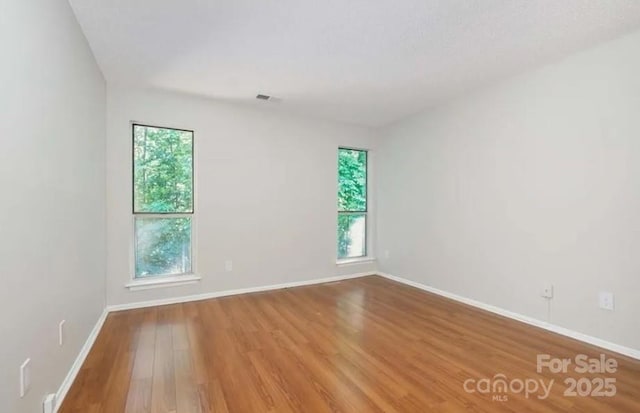 empty room with hardwood / wood-style flooring