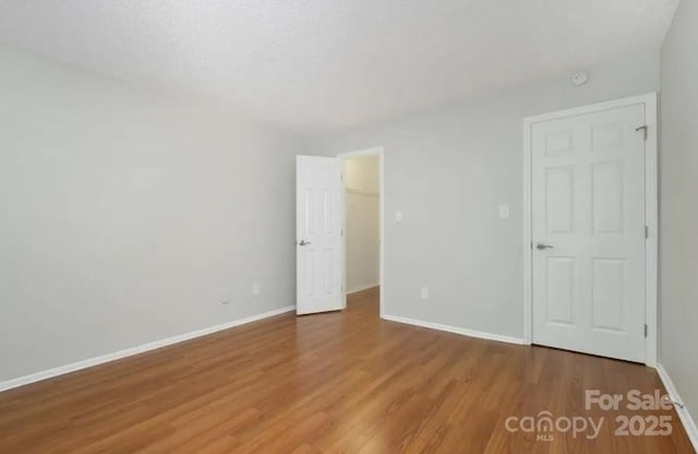 spare room with wood-type flooring