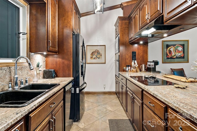 kitchen with light stone counters, sink, black appliances, and light tile patterned flooring