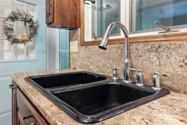 interior details featuring sink and backsplash