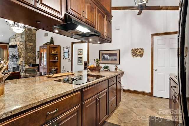 kitchen with black electric stovetop, light tile patterned floors, dark brown cabinetry, ceiling fan, and light stone countertops