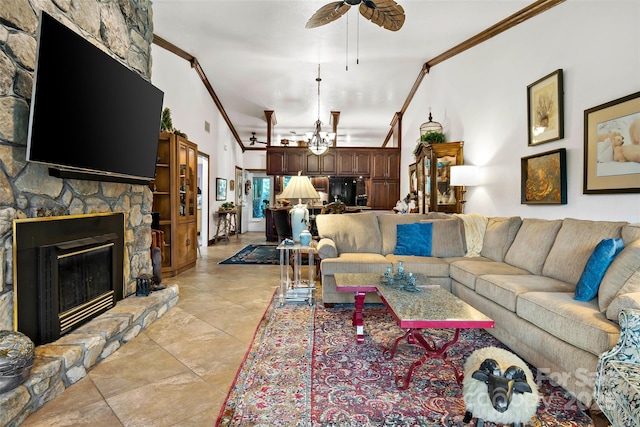 living room with ornamental molding, ceiling fan, and a fireplace