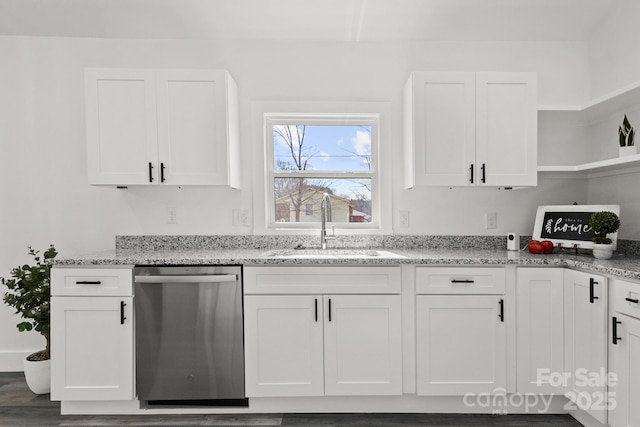 kitchen with white cabinetry, sink, light stone countertops, and dishwasher